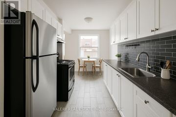 Toronto (Rockcliffe-Smythe) condo for rent - A kitchen with black and white appliances and cabinets.