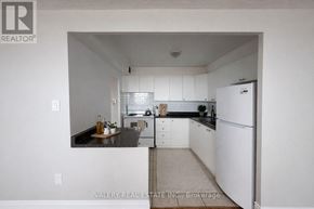 Toronto (Rockcliffe-Smythe) condo for rent - A living room with a couch, chair, and television.