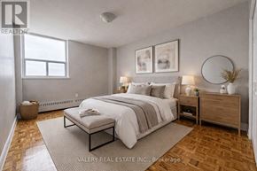 Toronto (Rockcliffe-Smythe) condo for rent - A white toilet sits next to a white sink in a tiled bathroom.