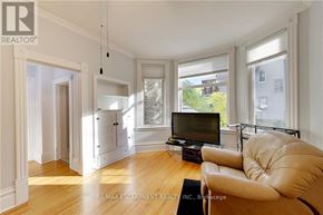 Sarnia apartment for rent - A living room with a leather sofa and a television.