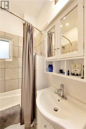 Sarnia apartment for rent - A white bathroom with a white sink and a white bathtub.