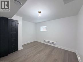 Hamilton apartment for rent - A room with a wooden floor and a black door.