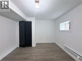 Hamilton apartment for rent - A room with a window and a black wardrobe.