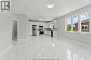 Windsor apartment for rent - A spacious kitchen with white marble flooring and modern appliances.