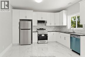 Windsor apartment for rent - A kitchen with white cabinets and a marble countertop.