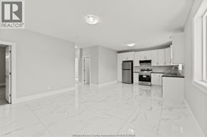 Windsor apartment for rent - A spacious kitchen with white cabinets and appliances.
