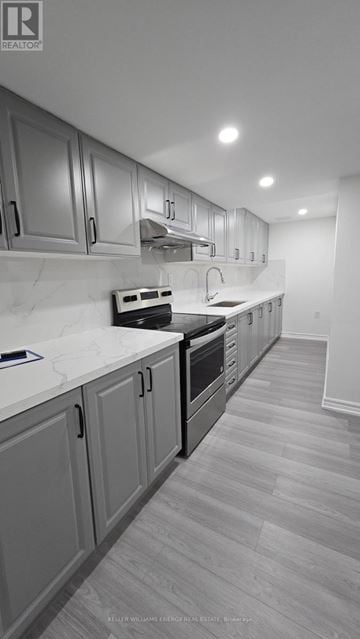 Clarington (Bowmanville) apartment for rent - A kitchen with a white counter top and grey cabinets.