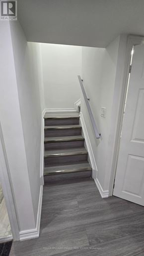 Clarington (Bowmanville) apartment for rent - A staircase with a grey carpeted floor and white walls.