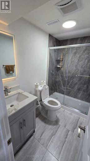 Clarington (Bowmanville) apartment for rent - A bathroom with a toilet, sink, and shower.