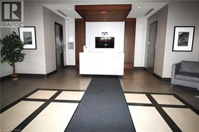 Hamilton condo for rent - A modern living room with a black television and a blue chair.