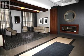 Hamilton condo for rent - A modern living room with a grey couch and a large abstract painting on the wall.