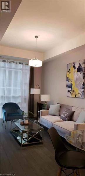 Hamilton condo for rent - A modern living room with a glass coffee table and a white sofa.