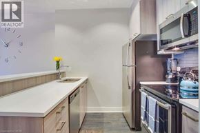 Hamilton condo for rent - A kitchen with a refrigerator, microwave, and oven.