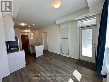 Milton (Fo Ford) condo for rent - A living room with a television and a sliding glass door.