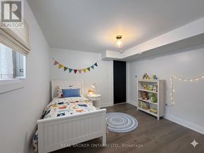 Hamilton (Delta) apartment for rent - A bedroom with a bed, a bookcase, and a rug.