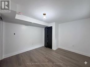 Hamilton (Delta) apartment for rent - A room with a wooden floor and a black wardrobe.