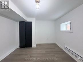 Hamilton (Delta) apartment for rent - A room with a window, a light bulb, and a wooden floor.