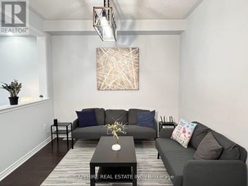 Milton (Cl Clarke) apartment for rent - A living room with a grey couch and a brown coffee table.
