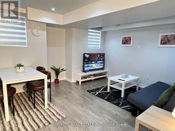 Milton (Cl Clarke) apartment for rent - A living room with a white table and chairs, a flat screen TV, and a couch.