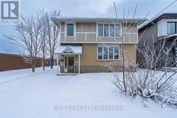 Ottawa duplex for rent - A house with snow on the ground and trees in front.