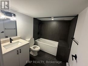 Ottawa duplex for rent - A bathroom with a toilet, sink, and bathtub.