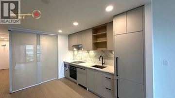 North Vancouver apartment for rent - A modern kitchen with a sink and cabinets.