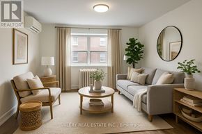 Toronto (Cabbagetown-South St. James Town) condo for rent - A living room with a grey couch, a wooden coffee table, a chair, a potted plant, and a round mirror on the wall.