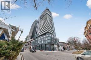 Burlington condo for rent - A tall building with a striped facade stands in the middle of a street.
