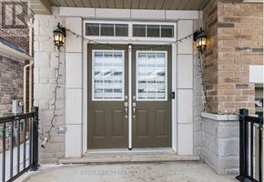 Halton Hills (Georgetown) apartment for rent - A house entrance with a green door and a sign that says RE/MAX Realty Services INC Brokerage.