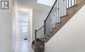 Halton Hills (Georgetown) apartment for rent - A hallway with a staircase and a door on the left side.