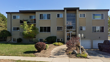 Guelph apartment for rent - Apartment building with a tree in front of it.