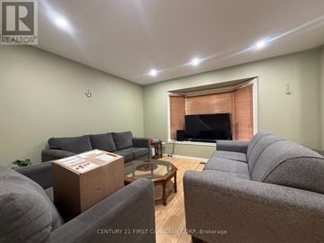 London South (South J) townhouse for rent - A living room with grey couches and a coffee table.