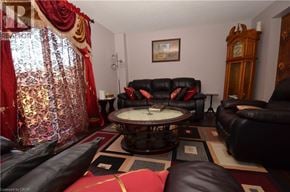Brantford townhouse for rent - A living room with a red and gold curtain.