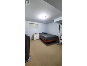 Vancouver apartment for rent - A bedroom with a bed, nightstand, and speaker.