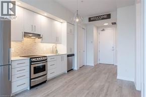 Grimsby condo for rent - A modern kitchen with a stove top oven and a refrigerator.