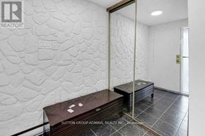 Toronto (Westminster-Branson) townhouse for rent - A room with a stone wall and a wooden bench.