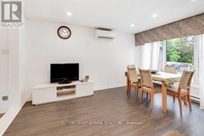 Toronto (Westminster-Branson) townhouse for rent - A living room with a television, chairs, and a table.