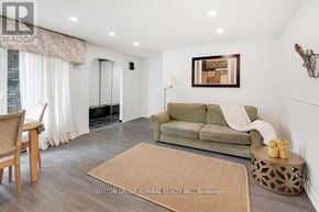 Toronto (Westminster-Branson) townhouse for rent - A living room with a green couch and a brown rug.