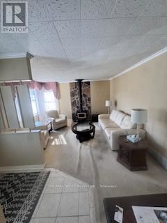 King (King City) apartment for rent - A living room with a white couch and a coffee table.