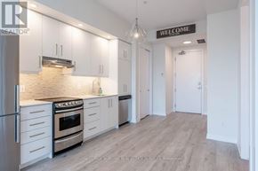 Grimsby (Grimsby Beach) condo for rent - A kitchen with white cabinets and a stove top oven.