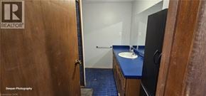 Kitchener apartment for rent - A bathroom with a blue counter top and a wooden door.
