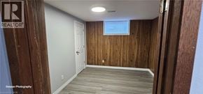 Kitchener apartment for rent - A room with wooden walls and a white door.