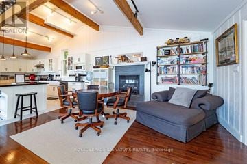Gravenhurst (Muskoka (S)) apartment for rent - A living room with a grey couch and a fireplace.
