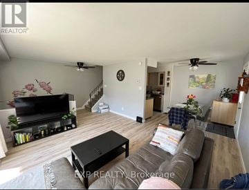 Ottawa townhouse for rent - A living room with a brown couch and a flat screen TV.