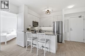 Toronto (Scarborough Village) condo for rent - A kitchen with white cabinets and a stainless steel refrigerator.