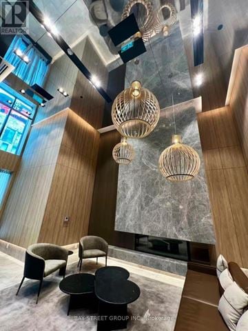 Toronto (Church-Yonge Corridor) condo for rent - A modern living room with a black coffee table and a large window.