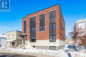 Ottawa multi-family for rent - A red brick building with a white trim and a black awning is in the foreground.