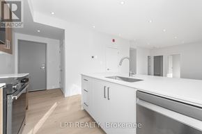 Ottawa multi-family for rent - A modern kitchen with white cabinets and stainless steel appliances.