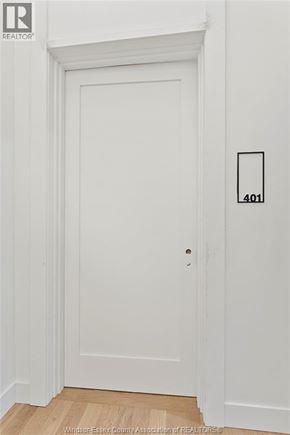 Amherstburg condo for rent - A white door with a number 401 on the wall next to it.