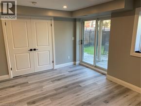 Cambridge apartment for rent - A room with a white door and a sliding glass door leading to a backyard.